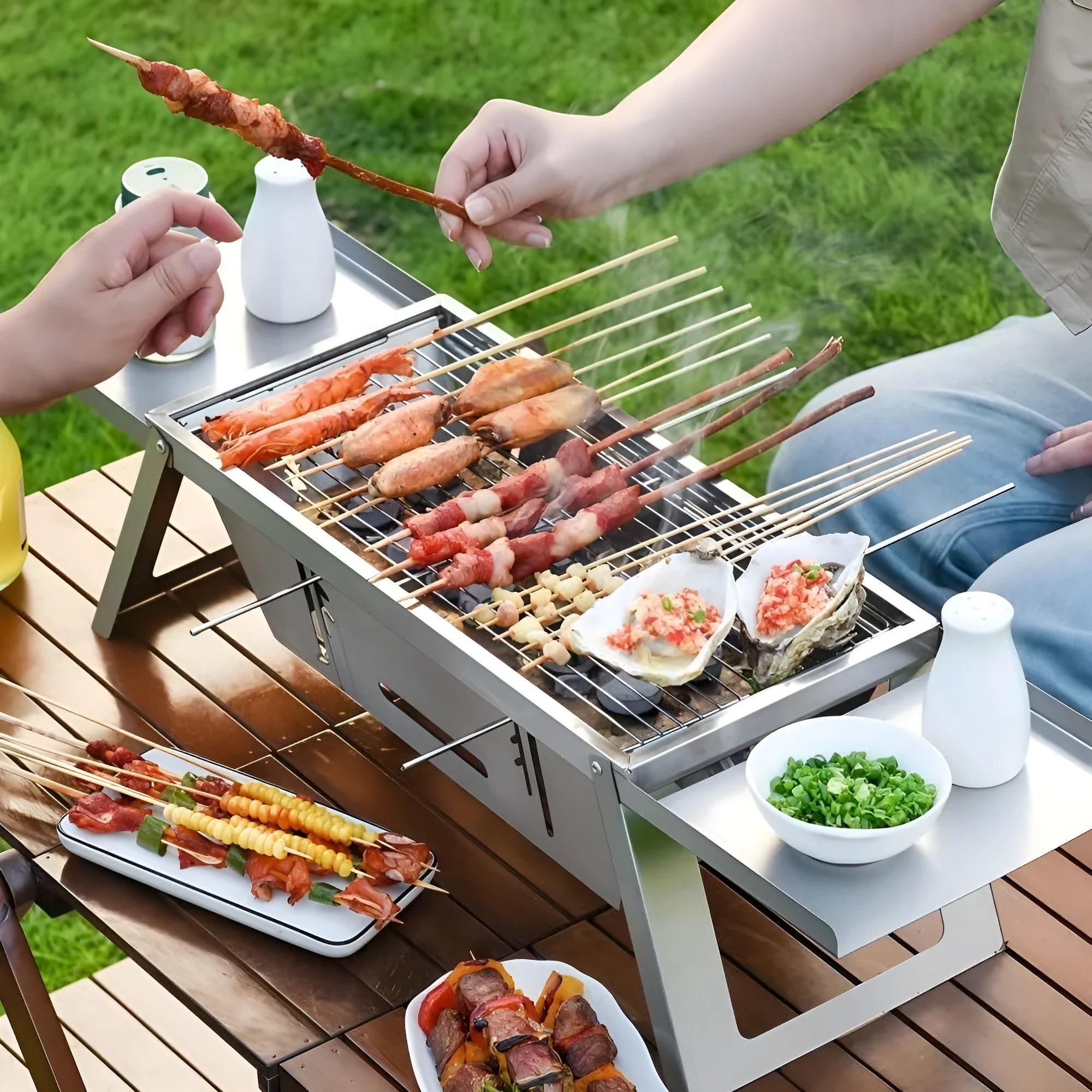 Small portable folding metal charcoal grill for outdoor barbecues.