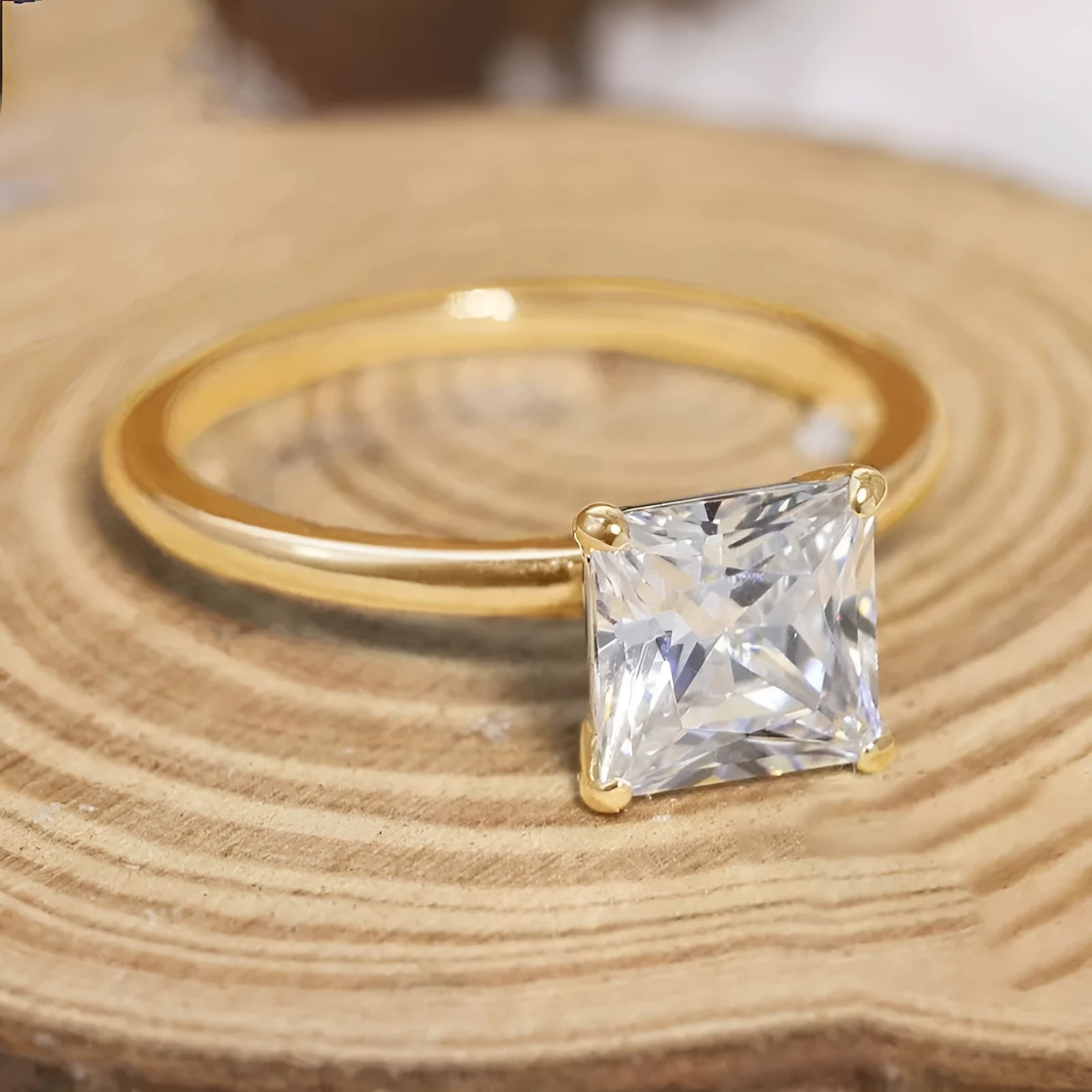 A simple geometric sterling silver ring with a round polished zirconium stone, shown in silver colour.