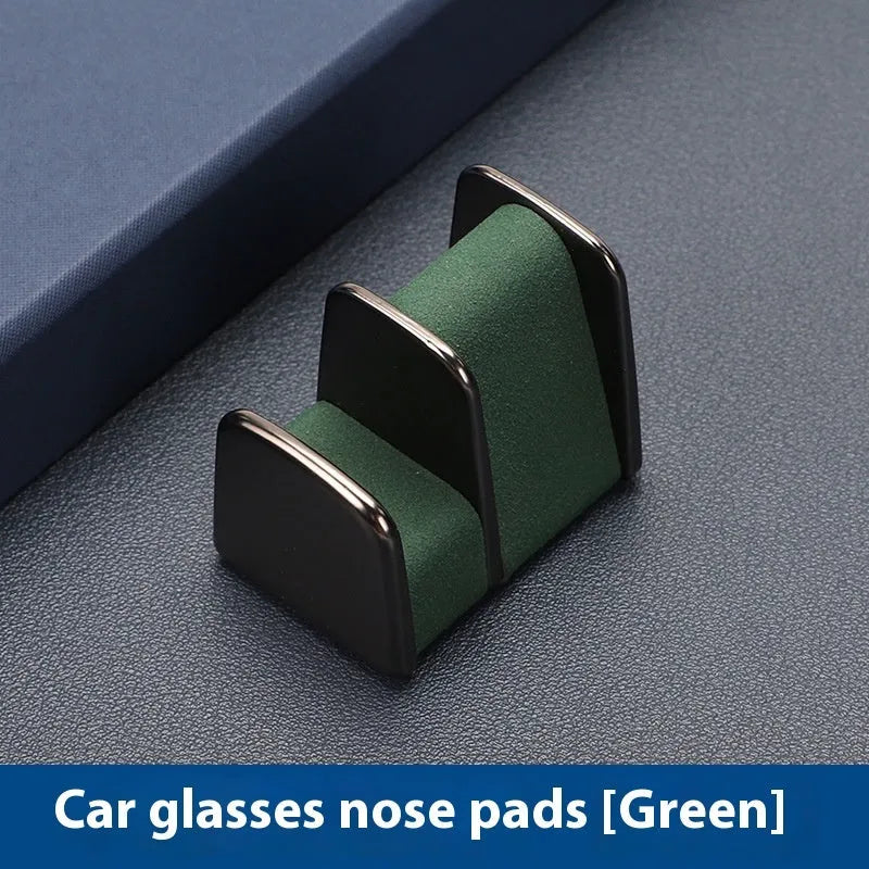 Green zinc alloy and leather car dashboard glasses clip holder with nose pad.