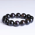 Polished crystal Pi Xiu bracelet with icy obsidian stone on wrist, showing geometric ethnic style.