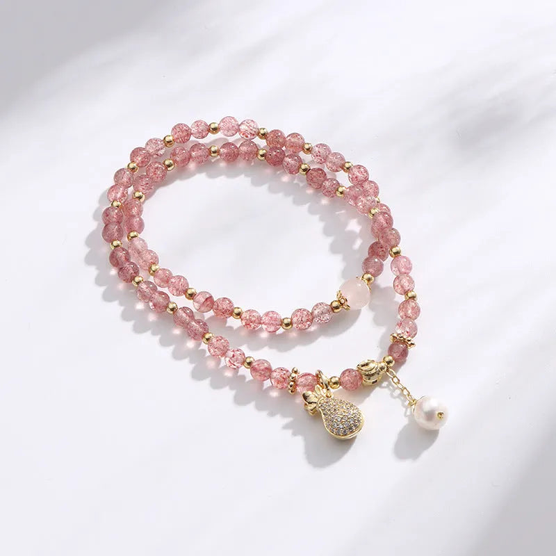 Women's strawberry quartz crystal bracelet with geometric design on wrist