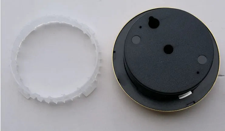 Silver analog hygrometer and thermometer with aluminium ring and dial showing temperature and humidity scales