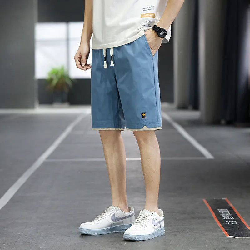 Man's loose-fit casual shorts in South Korea style, shown in a green colour, with a straight cut and elasticated waist.
