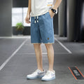 Man's loose-fit casual shorts in South Korea style, shown in a green colour, with a straight cut and elasticated waist.