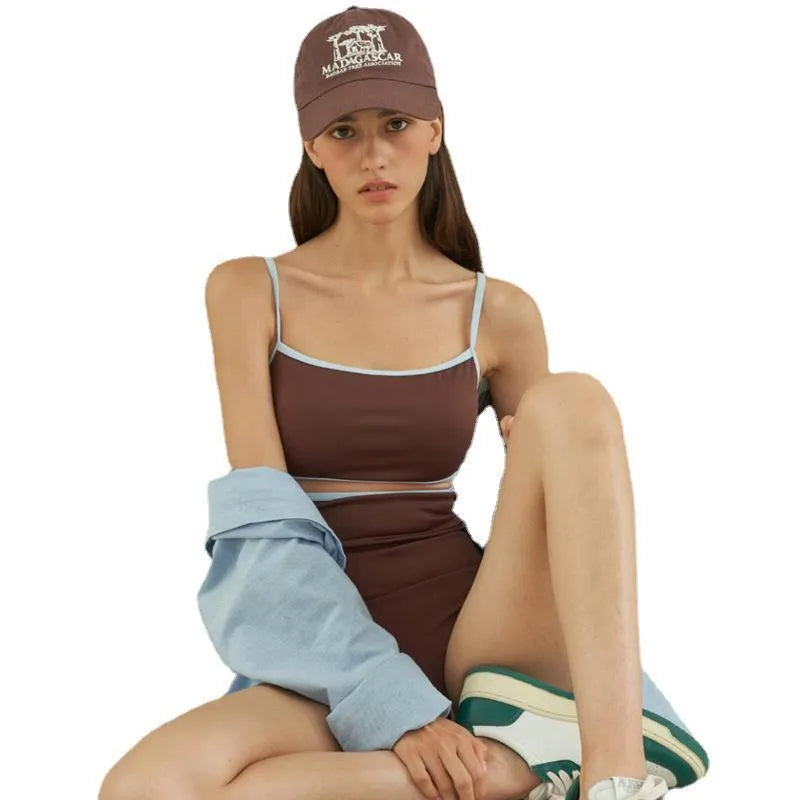 Brown women's one-piece swimsuit with triangle neckline design on mannequin