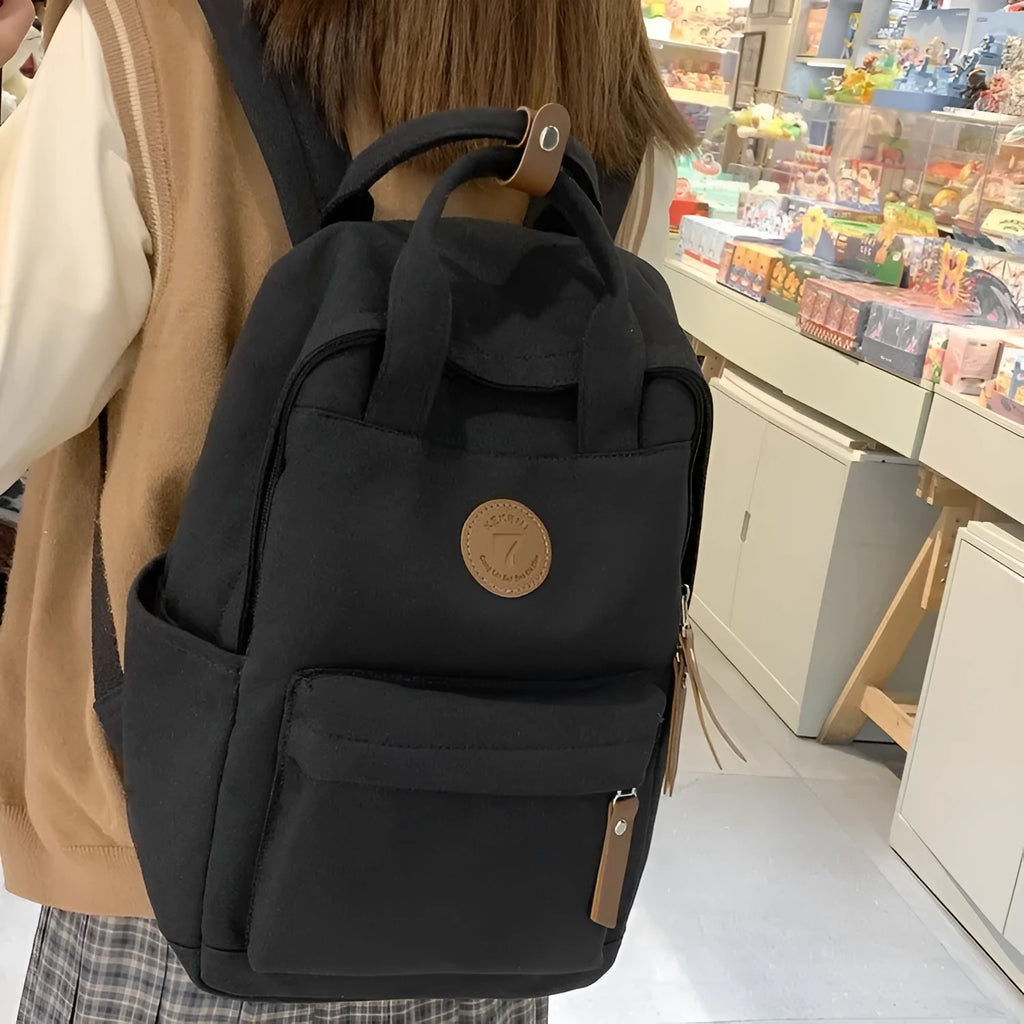 Black Oxford cloth retro backpack with curved shoulder straps for school and travel