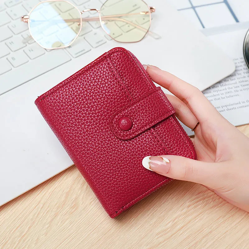 Short ladies wallet with lychee pattern in PU leather showing card slots and 2-fold construction