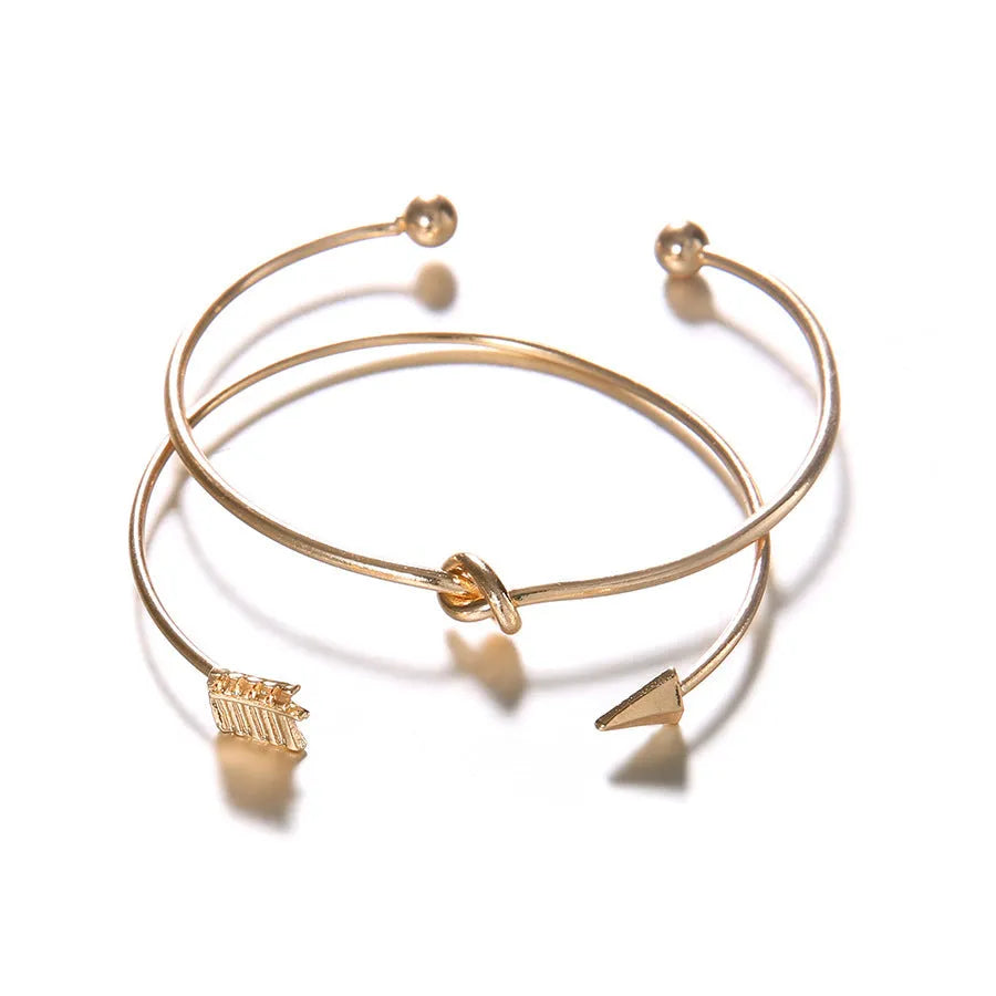 Gold electroplated women's vintage cuff bracelet with arrow knot detail