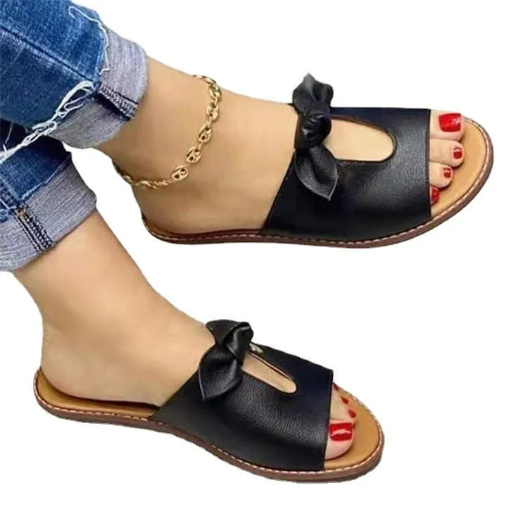 Ladies black fish mouth slippers with a bow decoration on the artificial PU upper