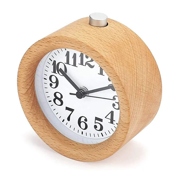 Solid beech wood square alarm clock with traditional analogue dial on wooden surface