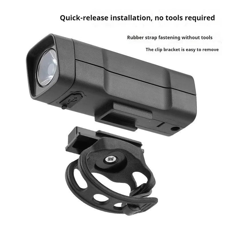 USB rechargeable bicycle headlight with quick-release strap bracket on handlebars.