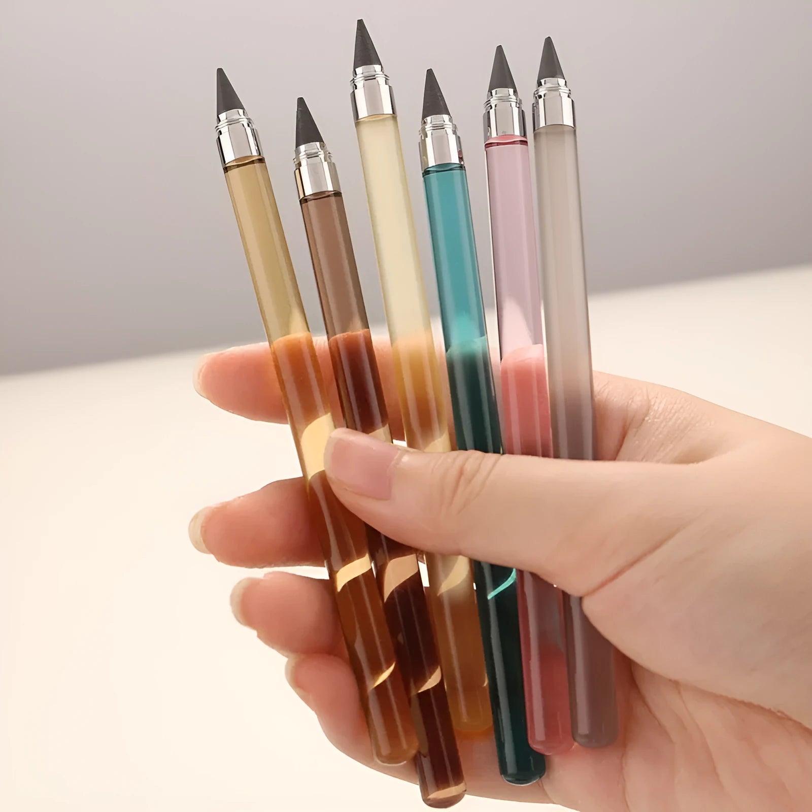 Clear acrylic eternal mechanical pencil with alloy writing tip and assorted coloured lead refills.