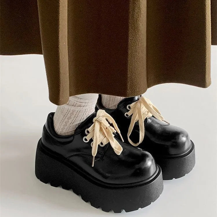 Matte black women's lace-up ankle boots with a chunky 6-8 cm heel and thick rubber sole.