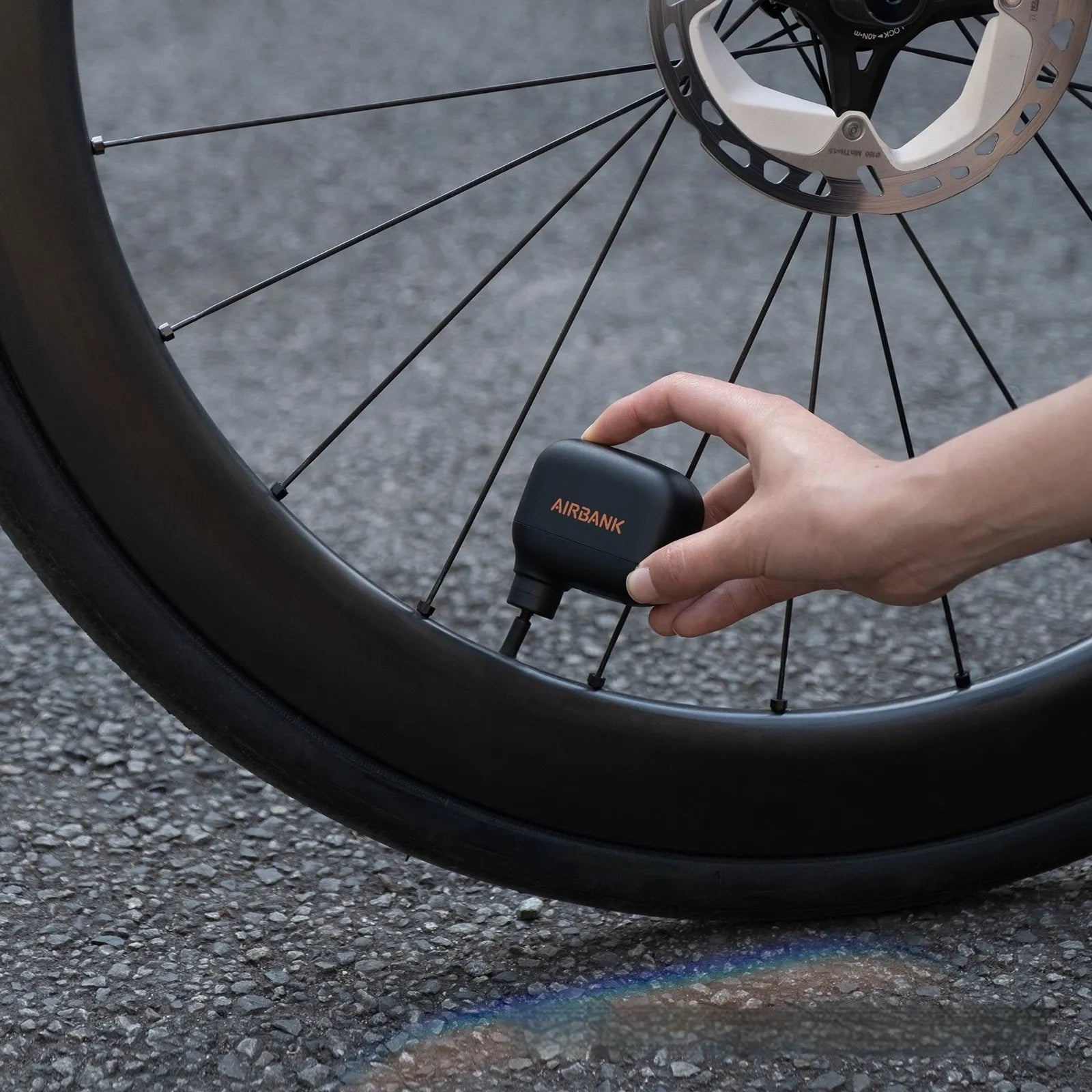 Black mini electric bicycle pump with USB charging port and compact dimensions