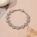 Gold and silver electroplated flower bracelets with coloured gems and crystals on a zinc alloy base.