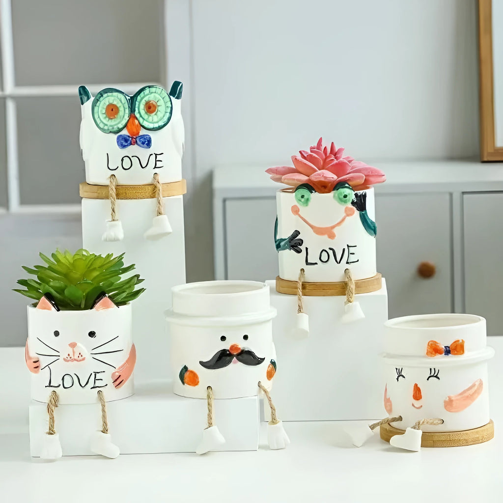 Ceramic hanging foot flowerpot for succulent plants in cartoon design on desktop
