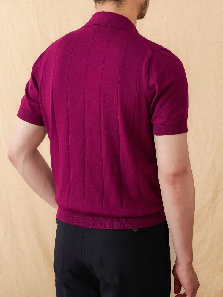 Man wearing a purple short sleeve polo shirt with a seagull collar, made from a knitted cotton and linen blend fabric.