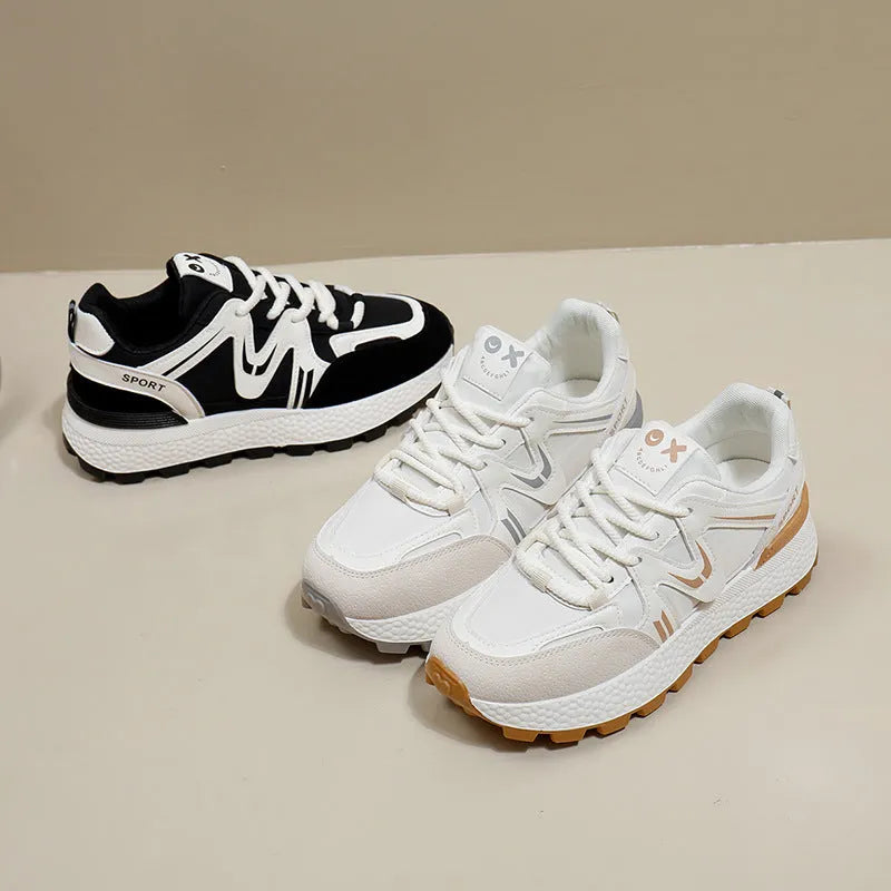 Women's black platform casual sneakers with round toe and front lace-up, showing artificial PU upper and flat sole.