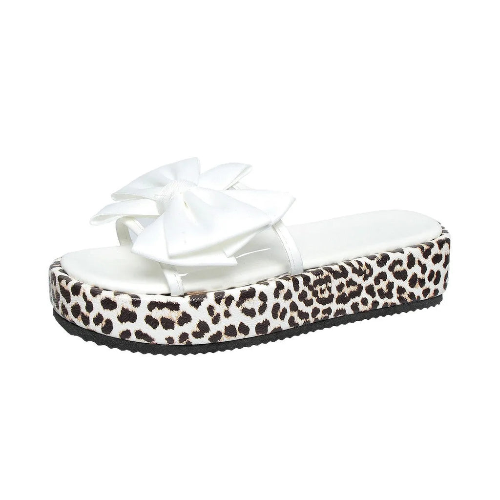 Women's black and white leopard print beach slippers with a thick sole and round toe design.