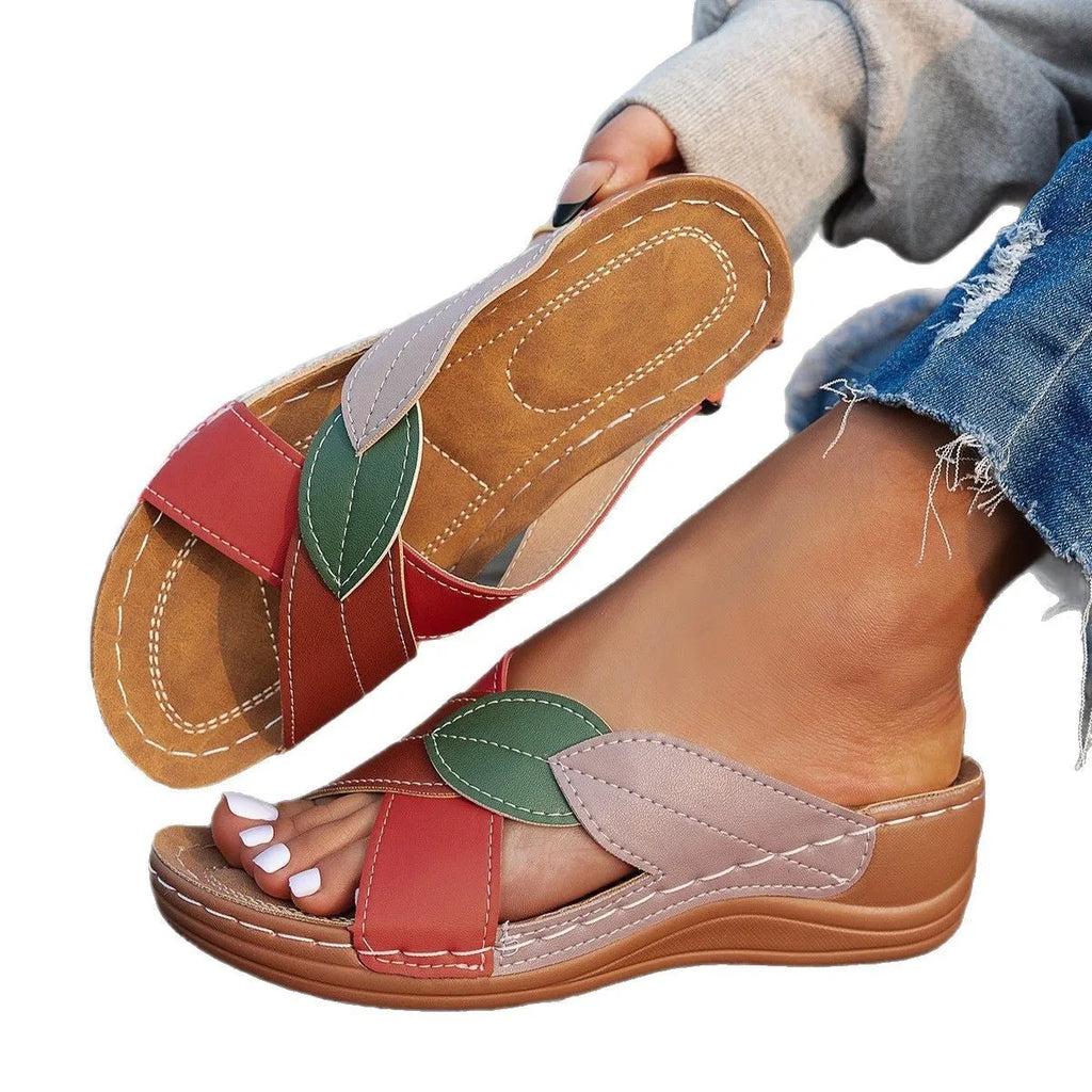 Women's black thick-soled slippers with cross-strap design and peep-toe opening