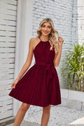 Women's black halter-neck strapless chiffon sundress with a pleated midi skirt and waist belt