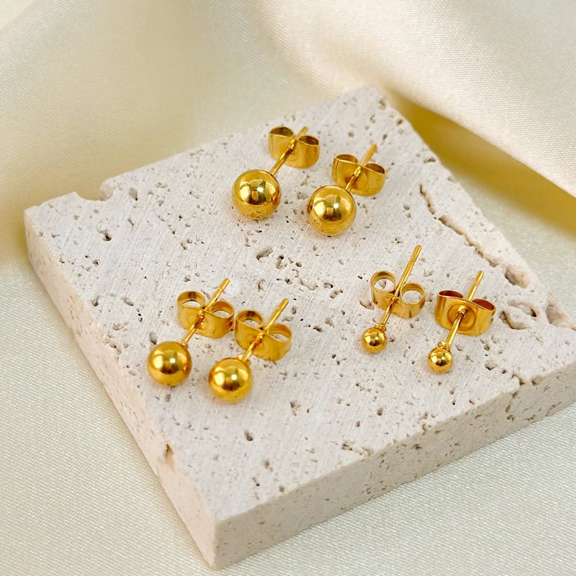 Stainless steel ball stud earrings with geometric round design and gold electroplated finish