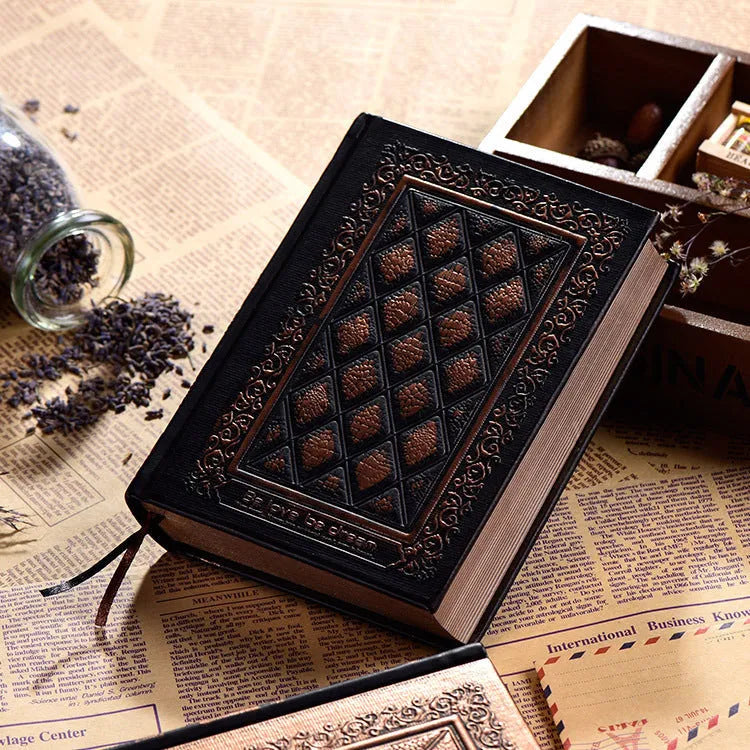 Bronze embossed faux leather A5 notepad with 192 thick unlined pages, lying open.