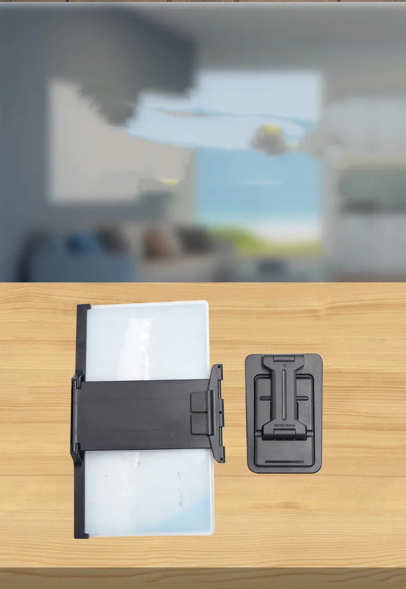 Black folding mobile phone screen amplifier and adjustable holder on a desktop, magnifying a smartphone display.