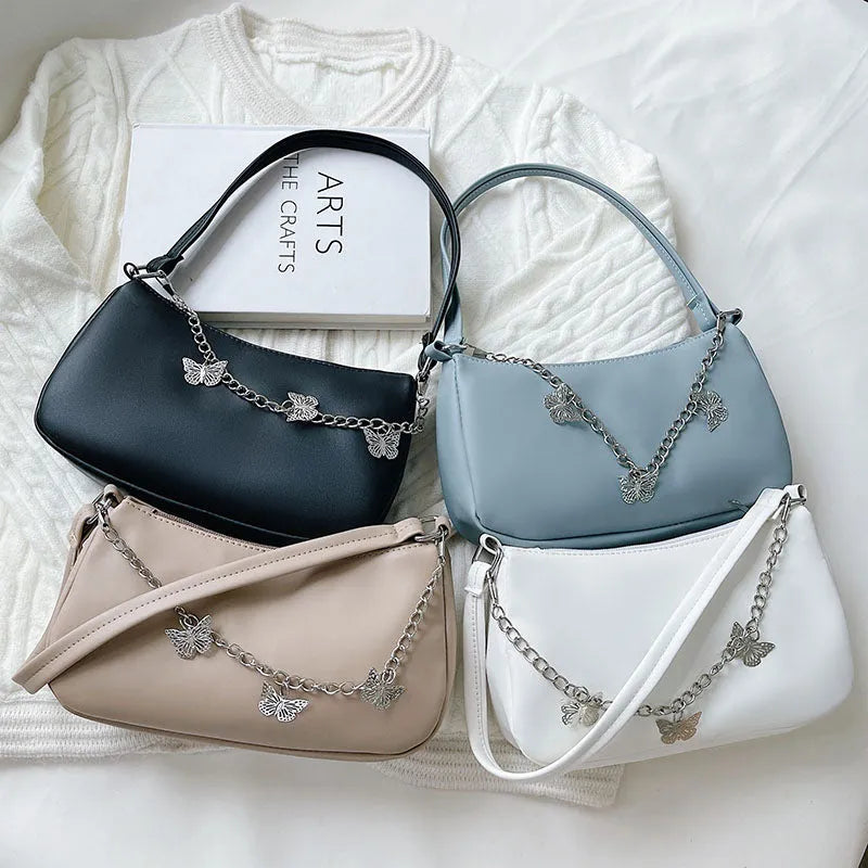 Horizontal square PU crossbody bag with chain strap in retro style showing internal phone and document pockets.