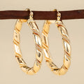 Women's geometric copper ear clips with ring and line elements in golden colour