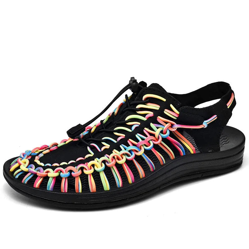 Woven sandals with elastic drawstring tie closure in rainbow colour on a rubber sole.