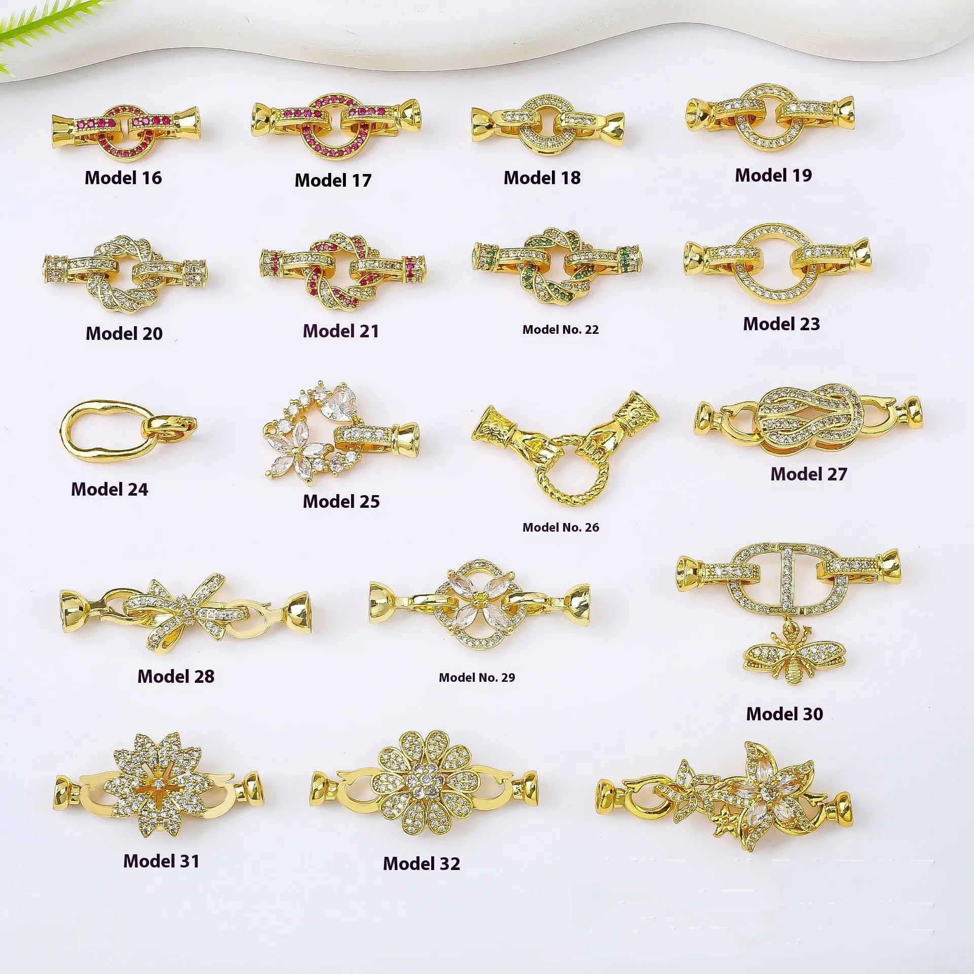 Small gold-colour metal jewellery clasp with a white pearl detail on the buckle