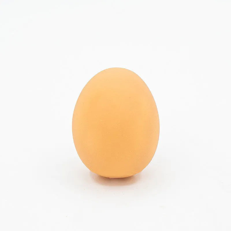 Egg-shaped dog chew toy with textured surfaces for dental cleaning and sound feature