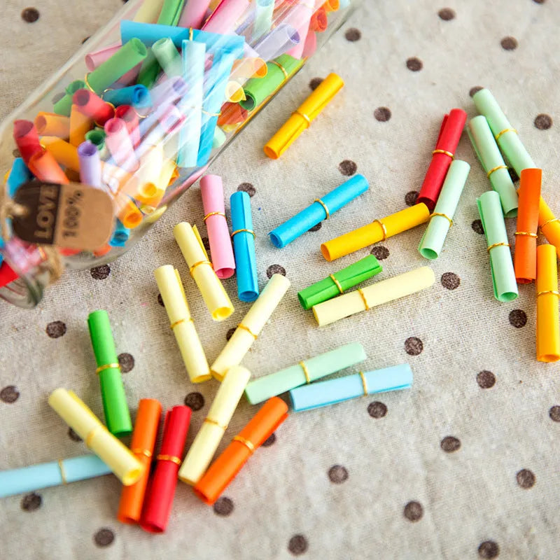 Assorted colour mini paper scrolls with eyelets for drift bottle messages and crafts.