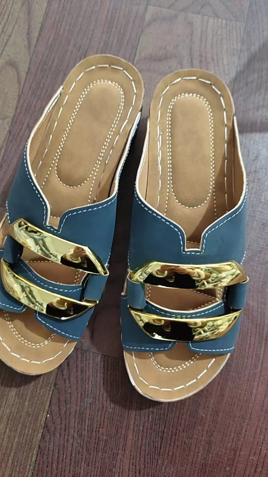 Roman style platform flip-flop sandals in white, black, khaki, and sea blue colours on a solid background.