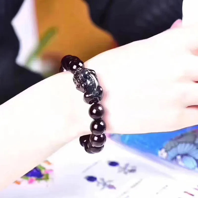 Natural ice colour obsidian crystal bead bracelet showing different bead size options on a wrist.