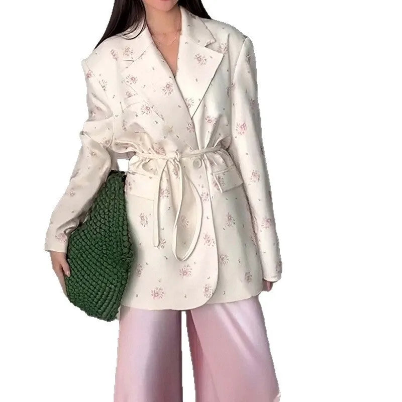 Women's suit jacket with lace-up detail at the collar and waist, shown in a floral print colour option.