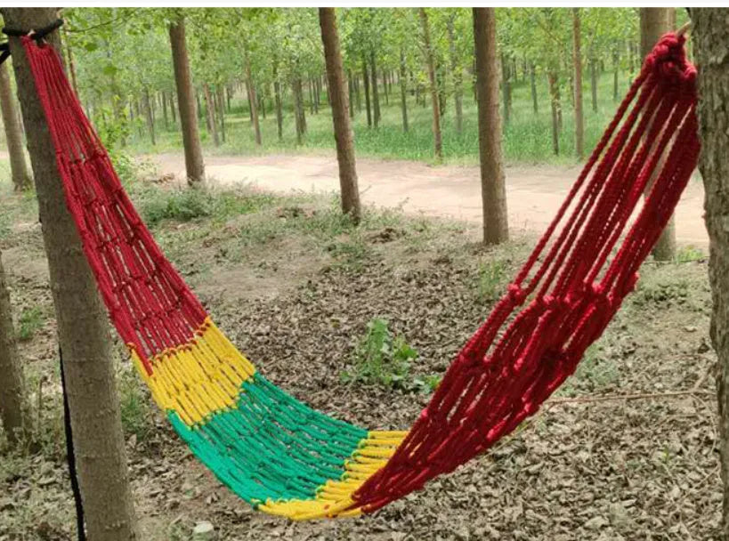 Outdoor nylon rope mesh hammock hanging between trees