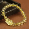 Yellow leather adjustable bracelet with a citrine-coloured artificial crystal Pi Xiu charm.