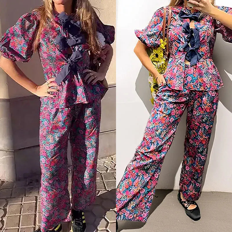Women's floral print trouser suit co-ord set with puff sleeve top and matching trousers.