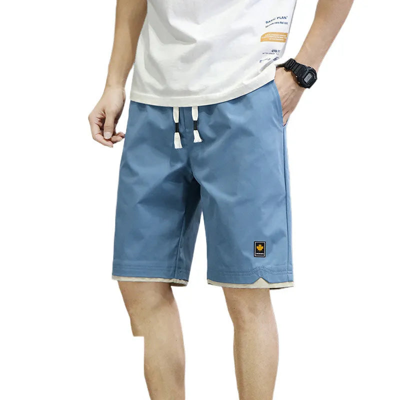 Man's loose-fit casual shorts in South Korea style, shown in a green colour, with a straight cut and elasticated waist.