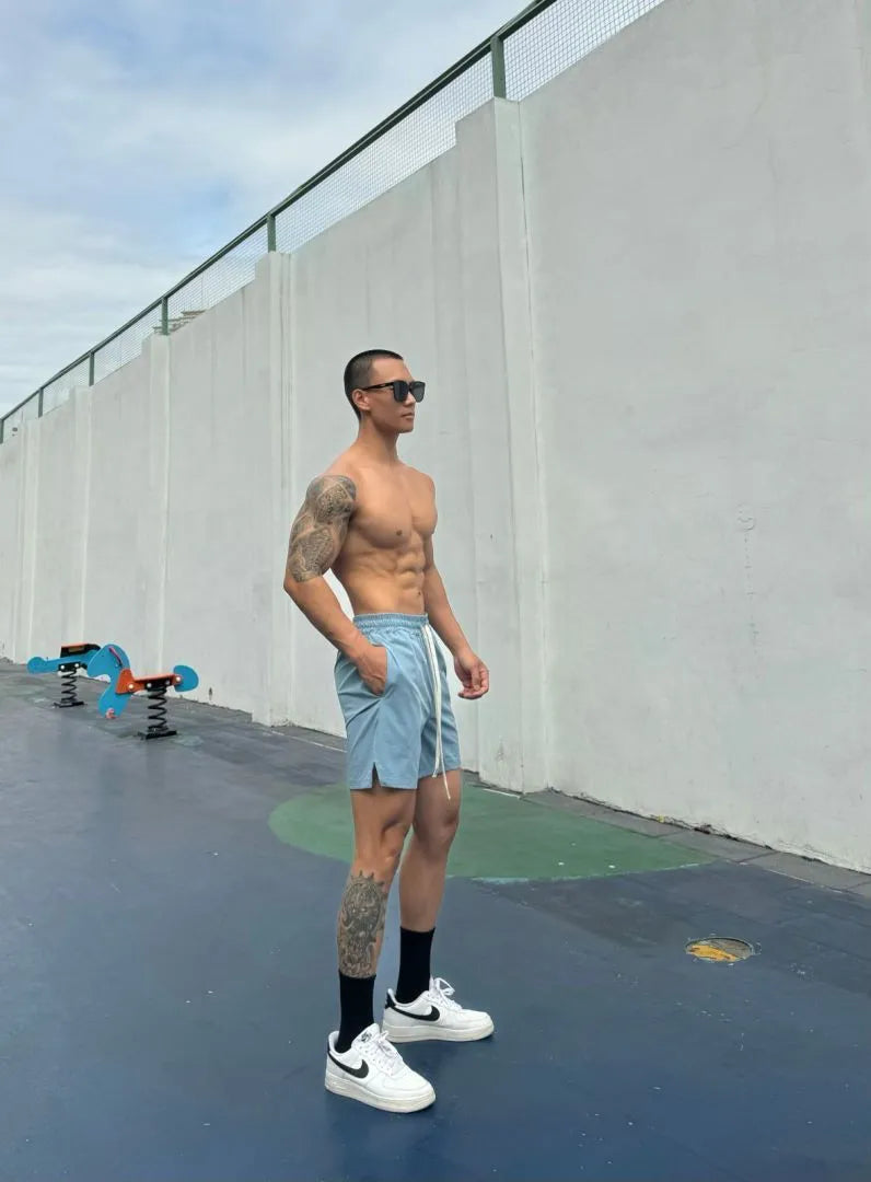 Men's quick-drying ice silk shorts in black, blue, grey and khaki colours showing quarter-length design