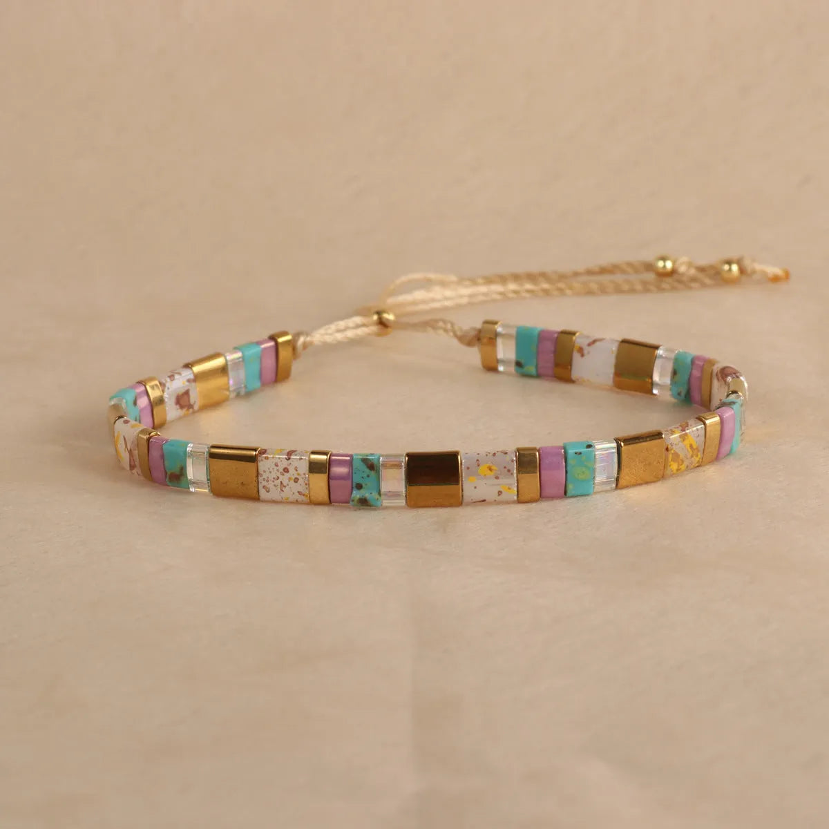 Geometric glass bead bracelet with pull design in milky white colour