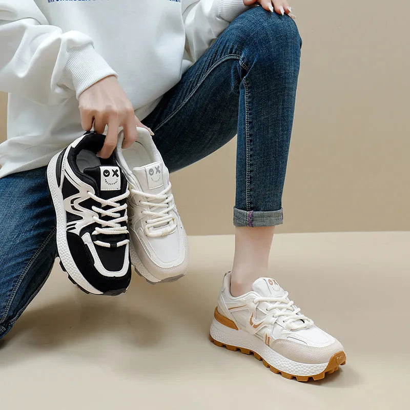 Women's black platform casual sneakers with round toe and front lace-up, showing artificial PU upper and flat sole.