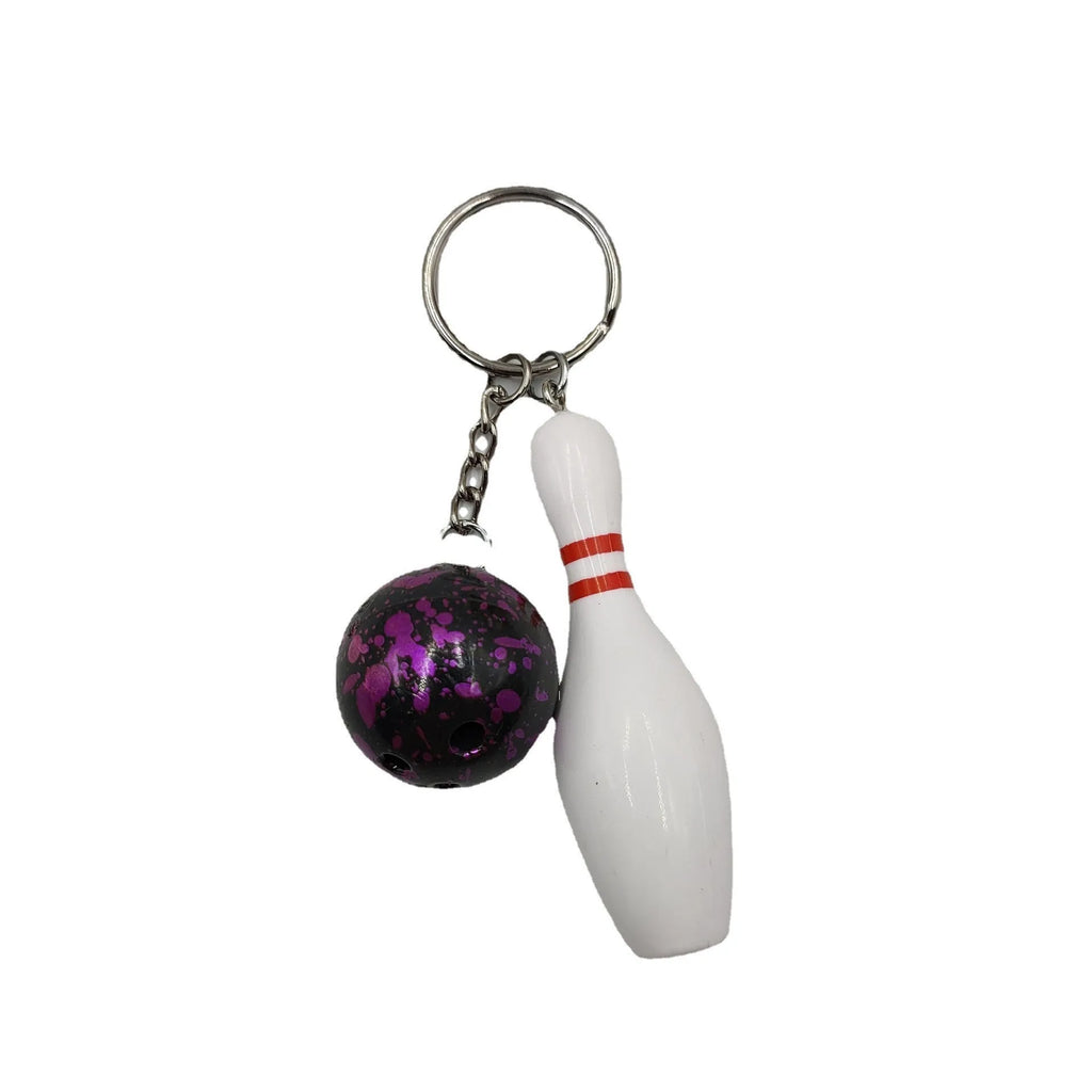 Miniature bowling ball keychain pendant in dark red, blue, purple, and green colours.