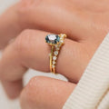 Gold plated flower-shaped ring with green zircon stone, shown in women's size.