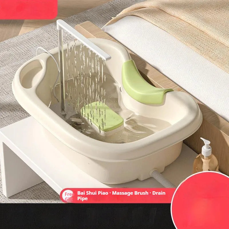 Portable plastic shampoo basin set with neck pillow, water pump, pipe, and brush in light pink and beige.