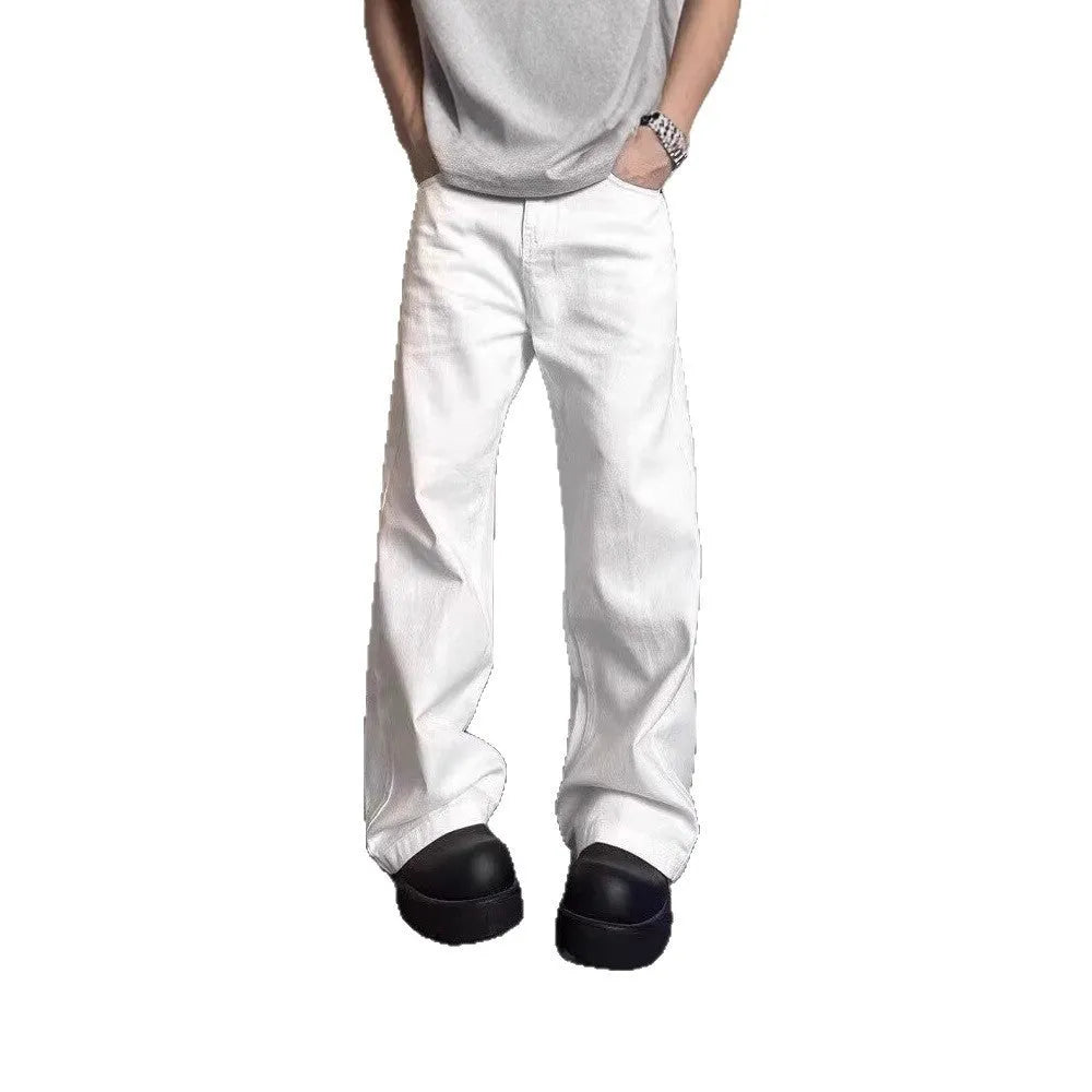 Men's white loose fit straight leg denim jeans on a mid waist with a zipper fly.
