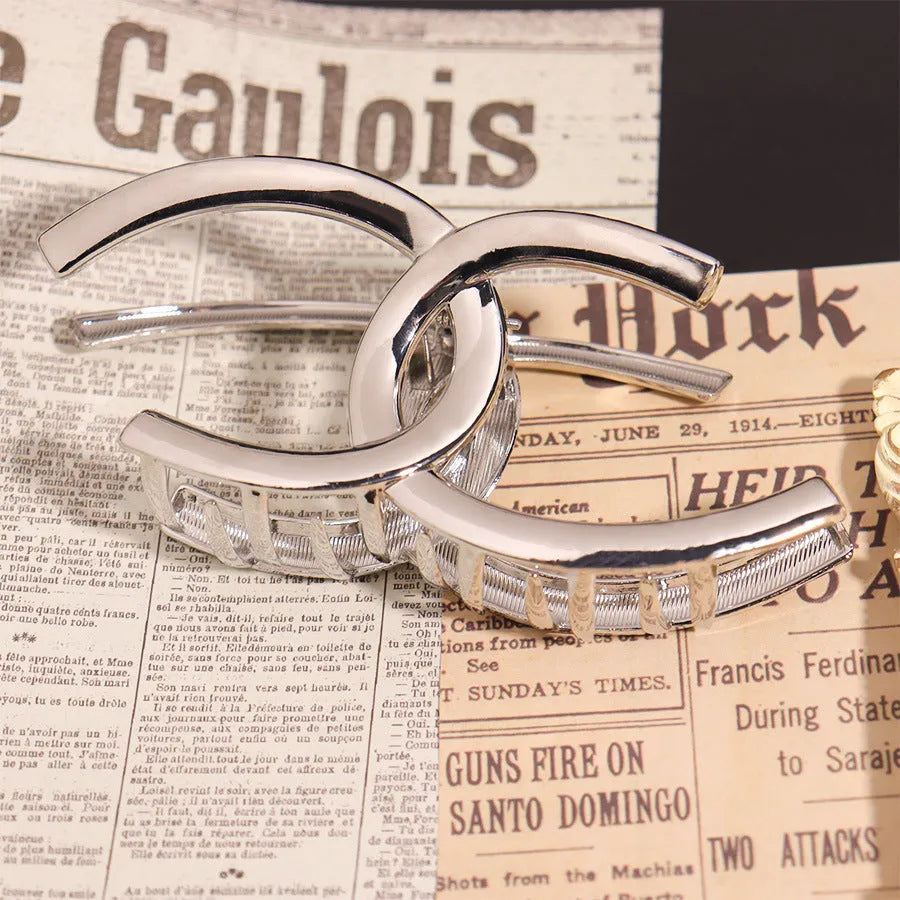 Silver electroplated metal hair claw barrette in a Korean-style design on white background