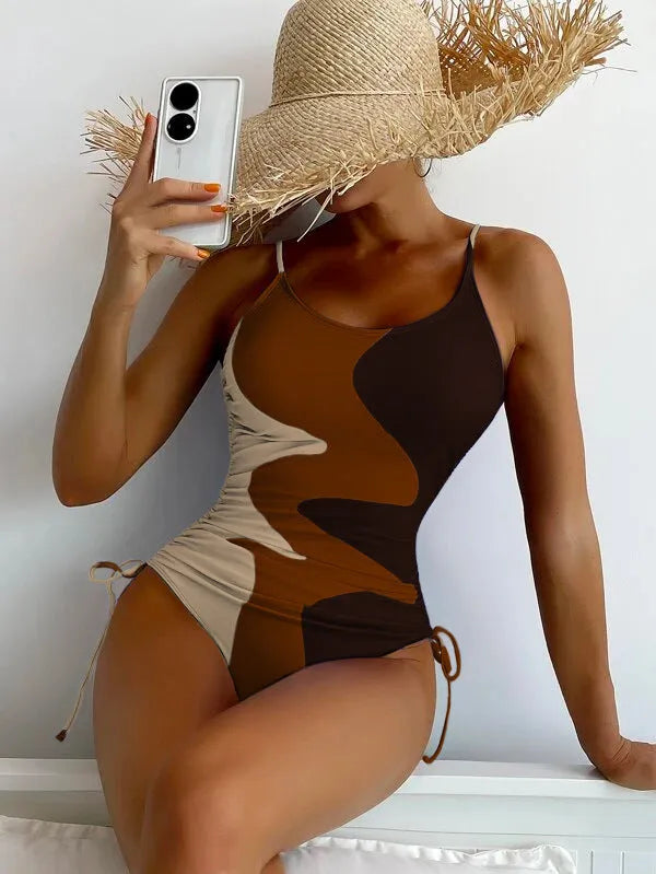 Women's sleeveless backless one-piece swimsuit in blue, purple, brown, or green with solid or striped pattern